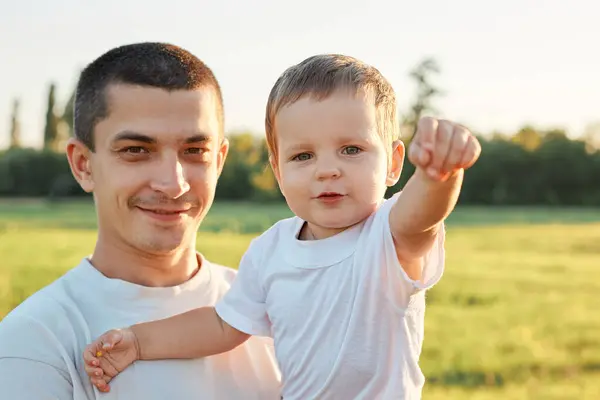 Smiling Attractive Man Holding Little Baby Girl While Standing Green Stock Picture