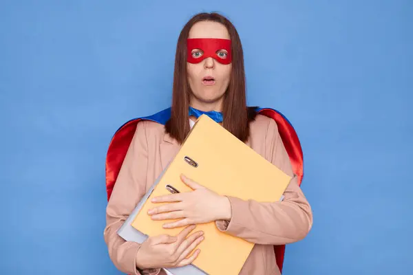 Geschokte Verbaasde Vrouw Superheld Kostuum Masker Met Mappen Geïsoleerd Blauwe Rechtenvrije Stockfoto's
