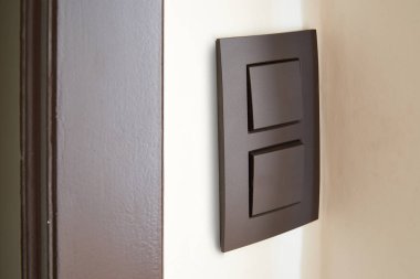Close-up of a Black light switch on White wall