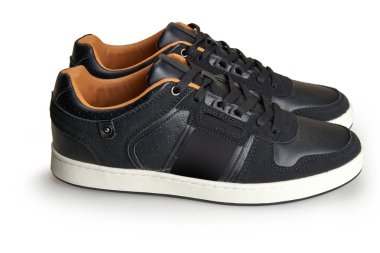 A pair of black leather shoes view from side. Isolated on white