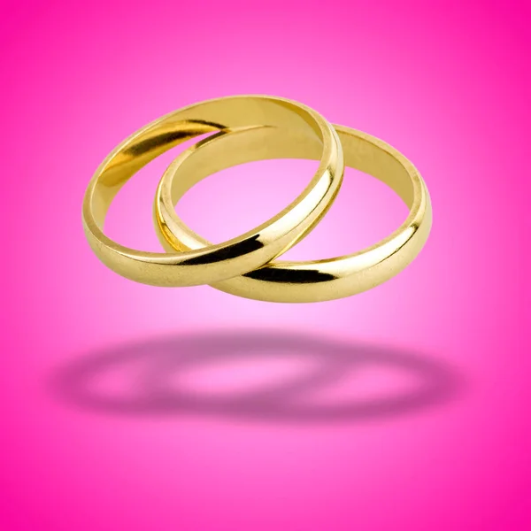 Staré Snubní Prsteny Plovoucí Růžovém Radiálním Pozadí — Stock fotografie