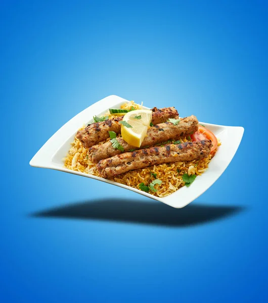 Schwebender Kabab Biryani Auf Weißem Teller Auf Blauem Hintergrund — Stockfoto