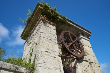 The entrance door and wheel of the Fortress at  Aix island in atlantic ocean clipart