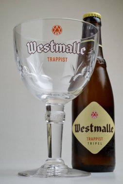 BRUSSELS, BELGIUM - January 12, 2025: Empty glass  and bottle of a authentic tripel Westmalle trappist clipart