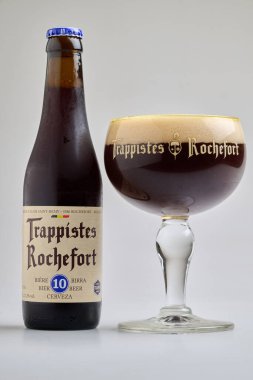 BRUSSELS, BELGIUM - January 29, 2025: Filled  glass  and foam with bottle  of a authentic 10 Rochefort trappist clipart