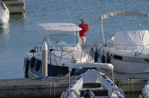 stock image Italy, Sicily, Mediterranean Sea, Marina di Ragusa (Ragusa Province); 31 October 2022, man on a luxury yacht in the port - EDITORIAL