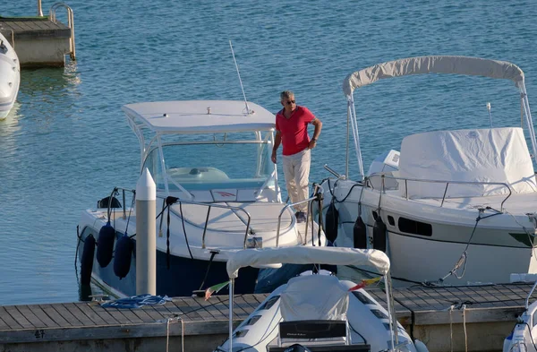 stock image Italy, Sicily, Mediterranean Sea, Marina di Ragusa (Ragusa Province); 31 October 2022, man on a luxury yacht in the port - EDITORIAL