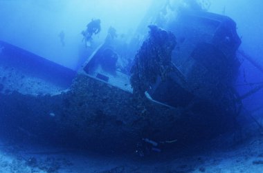 EGYPT, Red Sea, the wreck of a sunken ship and a scuba divers