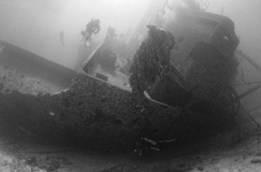 EGYPT, Red Sea, the wreck of a sunken ship and a scuba divers
