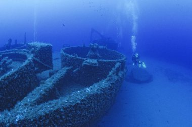 ITALY, Mediterranean Sea, Ponza Island; the wreck of a sunken ship and a scuba diver (FILM SCAN)
