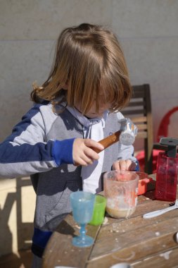 Italy, Sicily, Marina di Ragusa (Ragusa rovince); 6 years old male child playing outside in a balcony