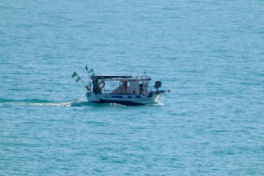 Italy, Sicily, Mediterranean Sea, Marina di Ragusa (Ragusa Province); local wooden fishing boat in the sea 