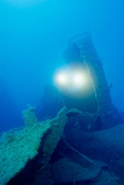 ITALY, Mediterranean Sea, Ponza Island; the wreck of a sunken ship and a scuba diver (FILM SCAN)