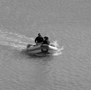 Italy, Sicily, Mediterranean Sea, Marina di Ragusa (Ragusa Province); 5 March 2023, men on a rubber boat in the port - EDITORIAL