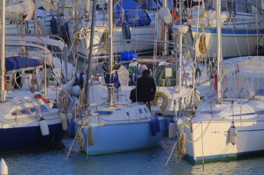 Italy, Sicily, Mediterranean sea, Marina di Ragusa (Ragusa Province); 5 March 2023, people and luxury yachts in the port - EDITORIAL
