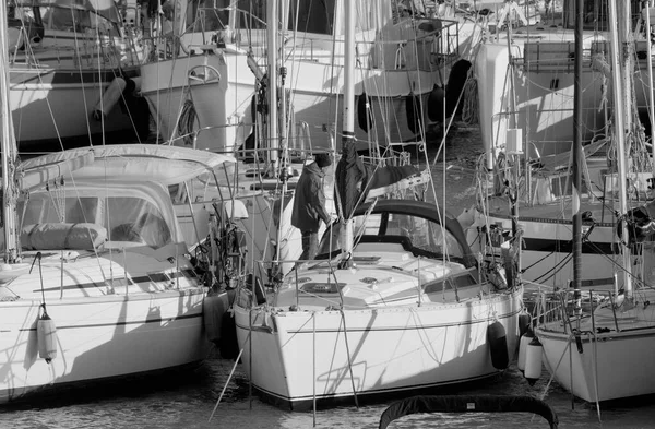 Italy, Sicily, Mediterranean Sea, Marina di Ragusa (Ragusa Province); 5 March 2023, man on a sailing boat in the port - EDITORIAL