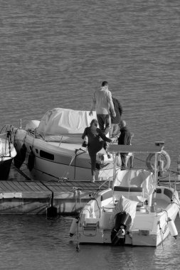Italy, Sicily, Mediterranean sea, Marina di Ragusa (Ragusa Province); people and luxury yachts in the port 