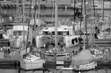 İtalya, Sicilya, Akdeniz, Marina di Ragusa (Ragusa Eyaleti); 8 Mayıs 2023, gün batımında limanda bir yelkenli teknesi ve lüks yatlarda insanlar - EDITORIAL