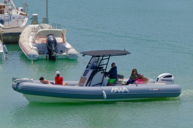 İtalya, Sicilya, Akdeniz, Marina di Ragusa (Ragusa Eyaleti); 3 Haziran 2023, limandaki kauçuk bir teknede insanlar - EDITORIAL