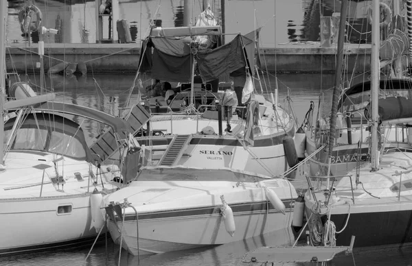 stock image Italy, Sicily, Mediterranean Sea, Marina di Ragusa (Ragusa Province); 30 June 2023, men on a sailing boat in the port - EDITORIAL