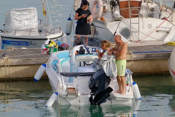 stock image Italy, Sicily, Mediterranean Sea, Marina di Ragusa (Ragusa Province); 8 July 2023, people on a motor boat in the port - EDITORIAL