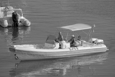 İtalya, Sicilya, Akdeniz, Marina di Ragusa (Ragusa ili); 13 Ağustos 2023, limandaki kauçuk bir teknede insanlar - EDITORIAL