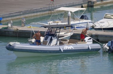 İtalya, Sicilya, Akdeniz, Marina di Ragusa (Ragusa ili); 20 Ağustos 2023, limandaki kauçuk bir teknede adamlar - EDITORIAL