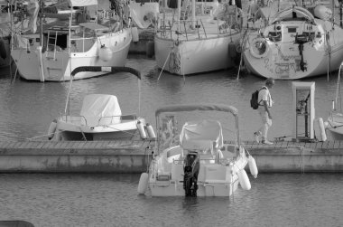 İtalya, Sicilya, Akdeniz, Marina di Ragusa (Ragusa ili); 21 Ekim 2023, limandaki insanlar, motorlu tekneler ve lüks yatlar - EDITORIAL