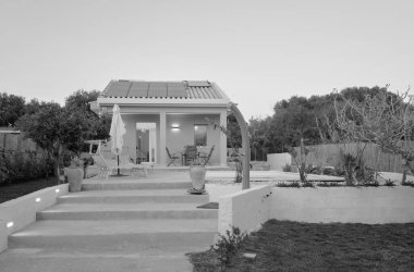 İtalya, Sicilya, Ragusa Eyaleti, kırsal kesim; 30 Mart 2023, zarif özel ev, yüzme havuzu manzarası ve gün batımında bahçe - EDITORIAL