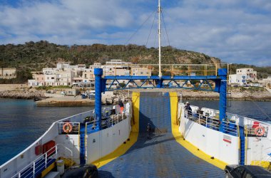 Itali, sicily, mediterranean sea, Egadi archipelago, levanzo island (Trapani Province); 20 March 2024, view of the rocky coast of the island and the port from a ferry boat - EDITORIAL clipart