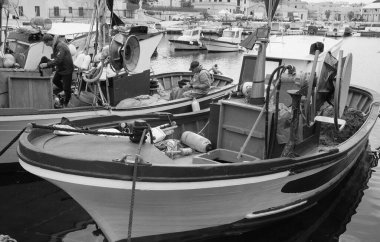 İtalya, Sicilya, Akdeniz, Egadi takımadaları, Favignana Adası (Trapani Eyaleti); 22 Mart 2024, limanda balıkçılar, balıkçılar, balıkçı tekneleri ve ağlar - EDITORIAL
