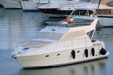 İtalya, Sicilya, Akdeniz, Marina di Ragusa (Ragusa Eyaleti); 27 Temmuz 2024, limanda lüks bir yatta bir adam - EDITORIAL