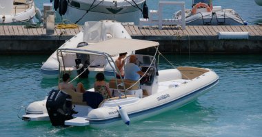 İtalya, Sicilya, Akdeniz, Marina di Ragusa (Ragusa Eyaleti); 28 Temmuz 2024, limandaki kauçuk bir teknede insanlar - EDITORIAL