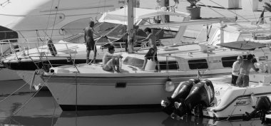 İtalya, Sicilya, Akdeniz, Marina di Ragusa (Ragusa ili); 6 Ağustos 2024, limandaki lüks yatlarda erkekler - EDITORIAL