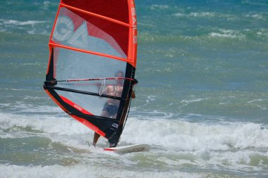 İtalya, Sicilya, Akdeniz, Donnalucata (Ragusa Eyaleti); 20 Ağustos 2024, dalgalara binen sörfçü - EDITORIAL