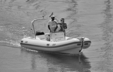 İtalya, Sicilya, Akdeniz, Marina di Ragusa (Ragusa ili); 23 Ağustos 2024, limanda bir kauçuk teknede çift - EDITORIAL