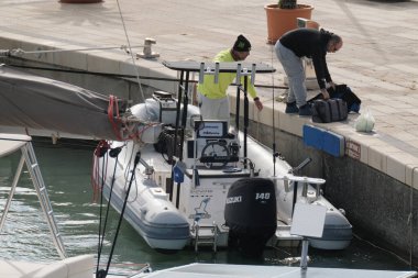 Italy, Sicily, Mediterranean Sea, Marina di Ragusa (Ragusa Province); 26 November 2024, sport fishermen on a rubber boat in the port - EDITORIAL clipart