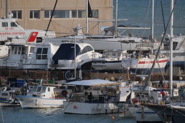 İtalya, Sicilya, Marina di Ragusa (Ragusa Eyaleti); 1 Mart 2025, limanda yerel balıkçı tekneleri ve lüks yatlar - EDITORIAL