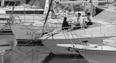 İtalya, Sicilya, Akdeniz, Marina di Ragusa (Ragusa Eyaleti); 24 Mayıs 2025, limanda lüks bir yatta insanlar - EDITORIAL