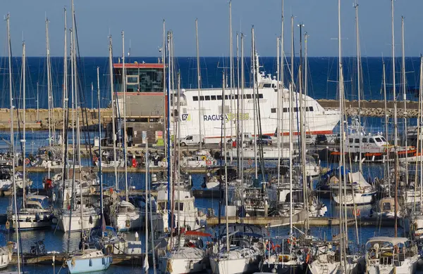 İtalya, Sicilya, Akdeniz, Marina di Ragusa (Ragusa ili); 25 Mayıs 2025, Sicilya 'yı Malta adasına bağlayan feribot ve limandaki lüks yatlar - EDITORIAL