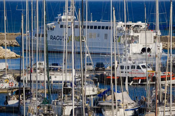 İtalya, Sicilya, Akdeniz, Marina di Ragusa (Ragusa ili); 25 Mayıs 2025, Sicilya 'yı Malta adasına bağlayan feribot ve limandaki lüks yatlar - EDITORIAL