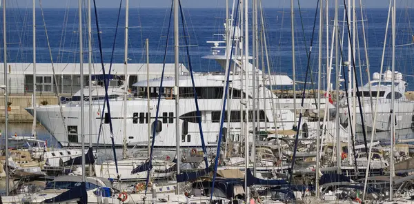İtalya, Sicilya, Akdeniz, Marina di Ragusa (Ragusa Eyaleti); limana giren büyük lüks bir yatın manzarası 