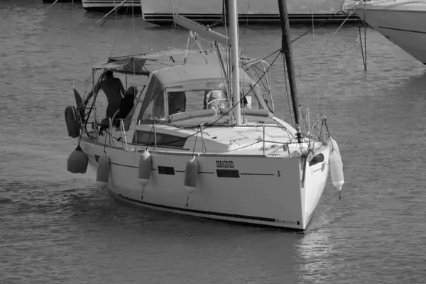 İtalya, Sicilya, Akdeniz, Marina di Ragusa (Ragusa ili); 8 Haziran 2025, limandaki bir yelkenli teknesinde insanlar - EDITORIAL