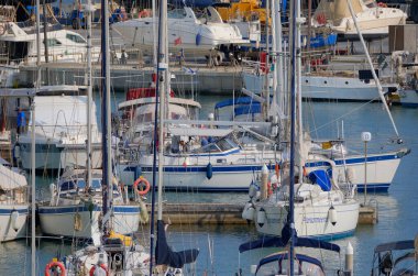 İtalya, Sicilya, Akdeniz, Marina di Ragusa (Ragusa ili); 21 Haziran 2025, limandaki bir yelkenli teknesinde çift - EDITORIAL