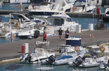 İtalya, Sicilya, Akdeniz, Marina di Ragusa (Ragusa ili); 4 Ağustos 2025, limandaki insanlar, motorlu tekneler ve lüks yatlar - EDITORIAL