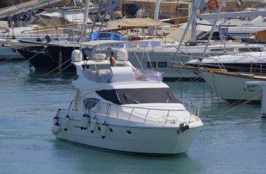 İtalya, Sicilya, Akdeniz, Marina di Ragusa (Ragusa Eyaleti); 11 Ağustos 2025, limanda lüks bir yatta adam - EDITORIAL