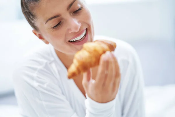Young woman on bed with food catering. High quality photo