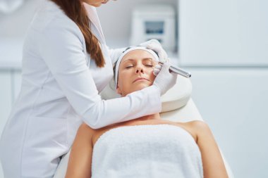 Woman having permanent eyebrows cosmetology treatment. High quality photo