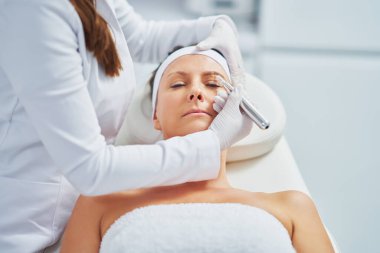Woman having permanent eyebrows cosmetology treatment. High quality photo