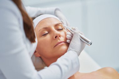 Woman having permanent eyebrows cosmetology treatment. High quality photo